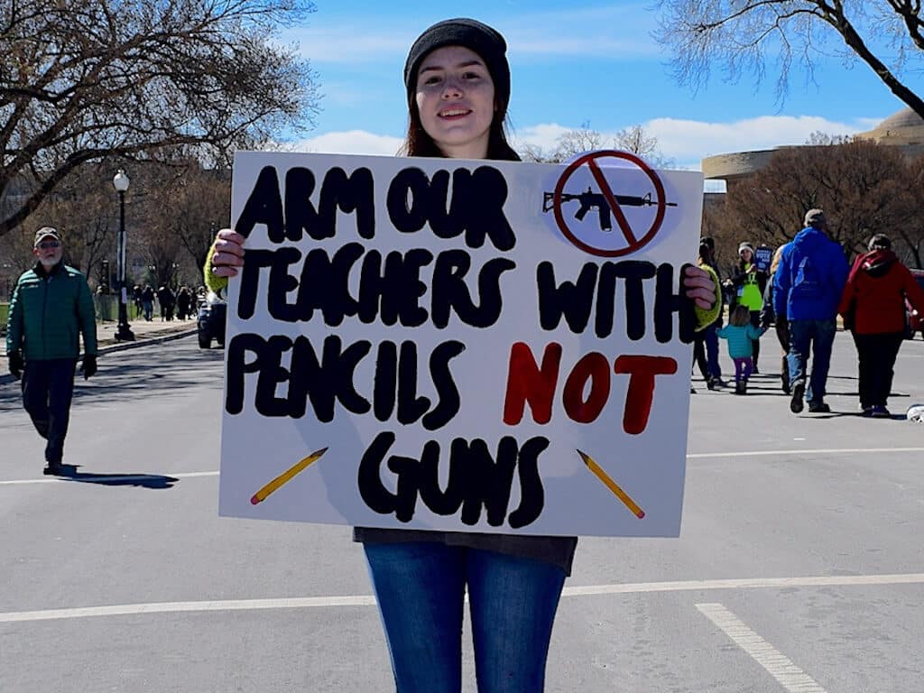 2nd Amendment debate Woman holding protest sign