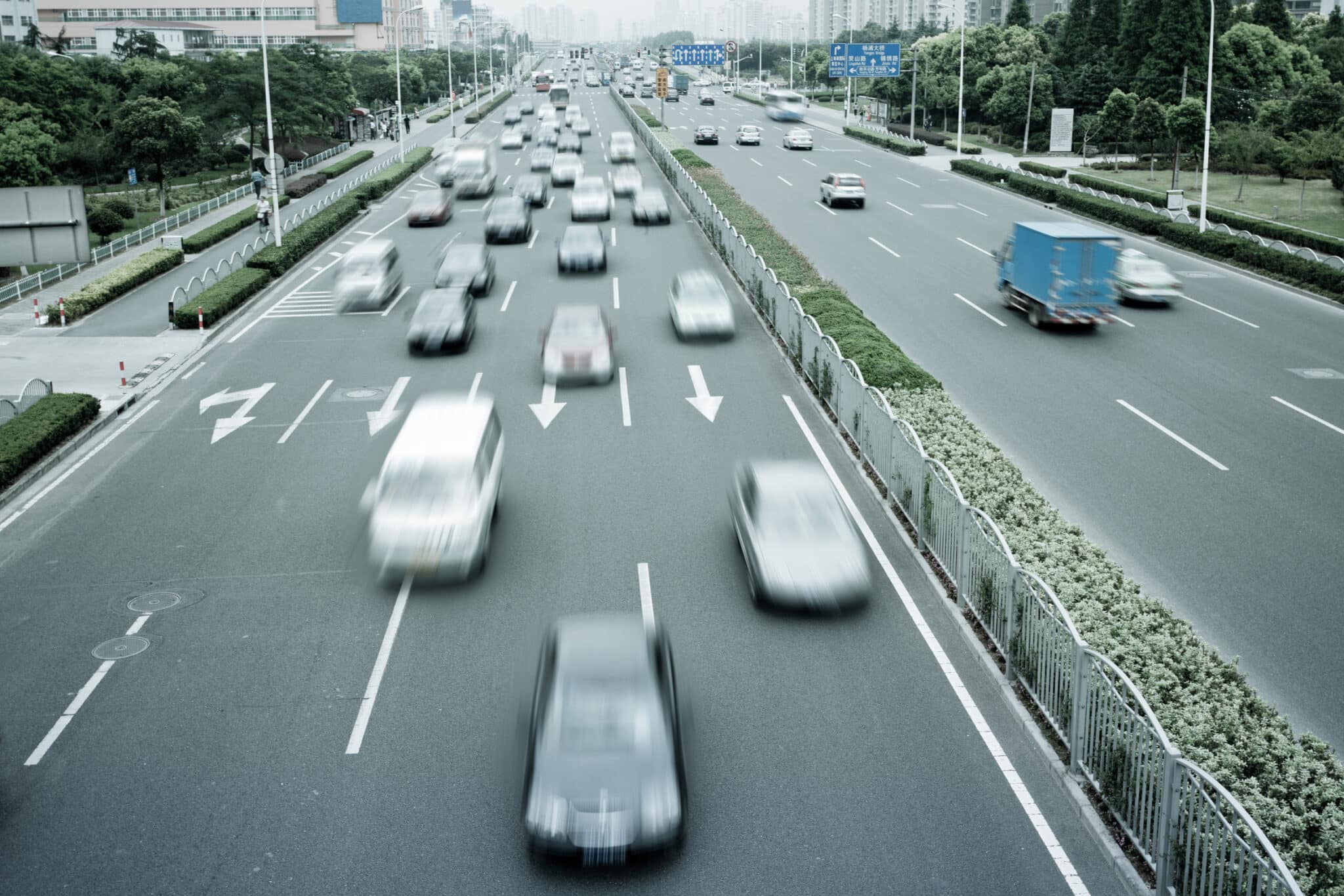 A view of cars driving on a 4 lined highway.
