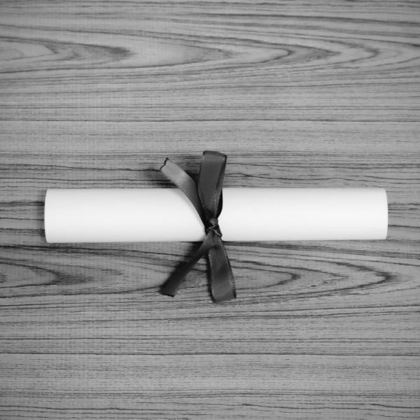 Black and white diploma symbolizing master's degree