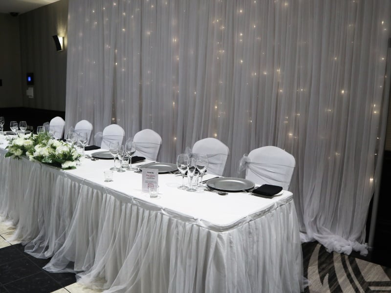 bridal table with skirting and fairy light backdrop
