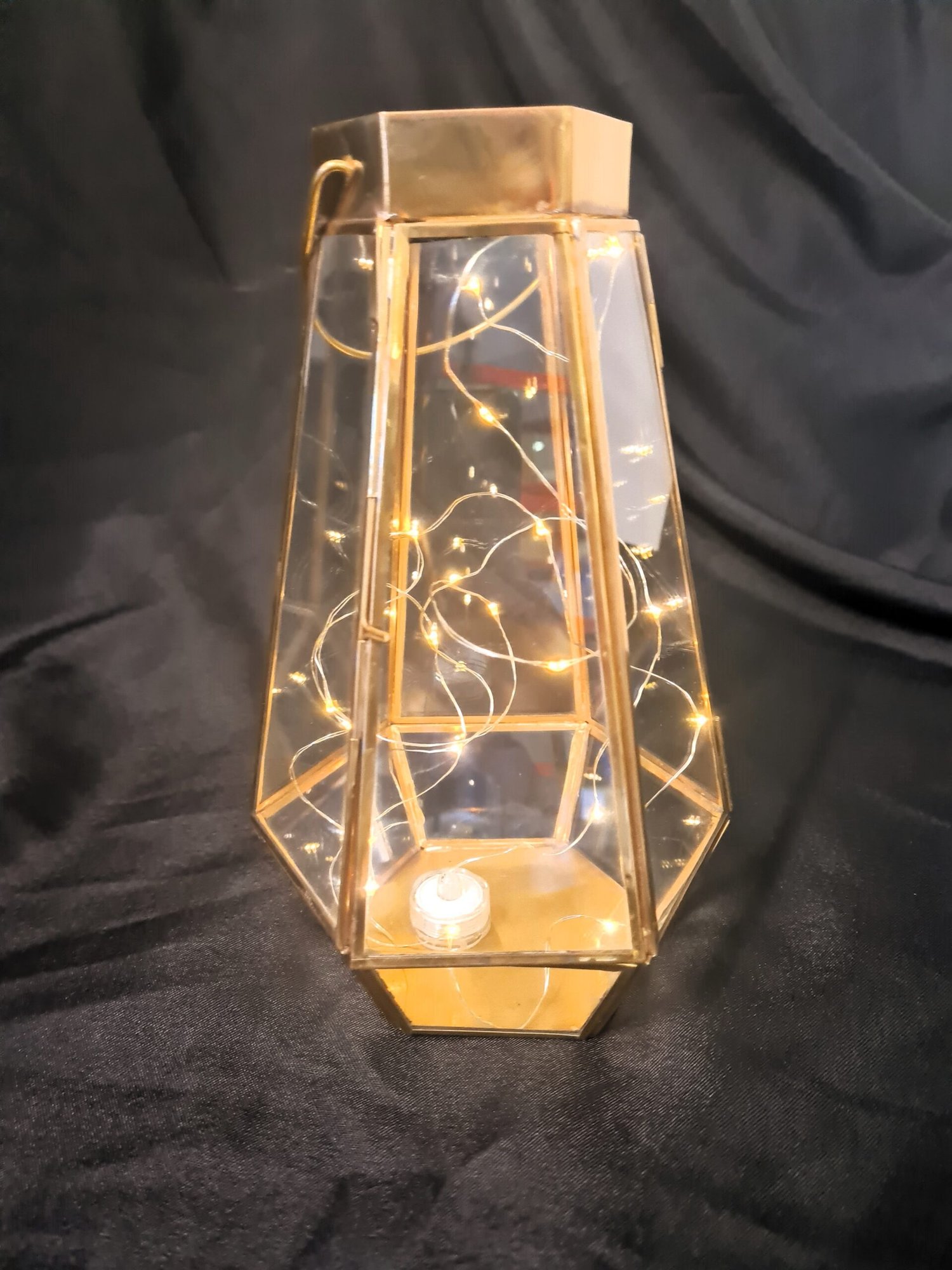 gold hexagonal lantern with seed lights
