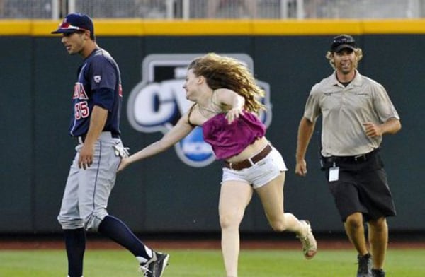 In "I Would Date You But… (part 2)", a woman is sprinting alongside an umpire on a baseball field.