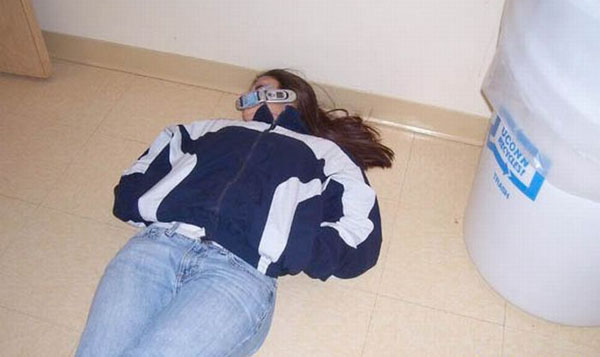 A woman wearing a mask on the floor, as girls get wild.