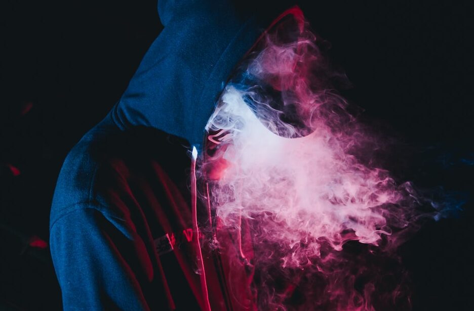 man in black hoodie smoking